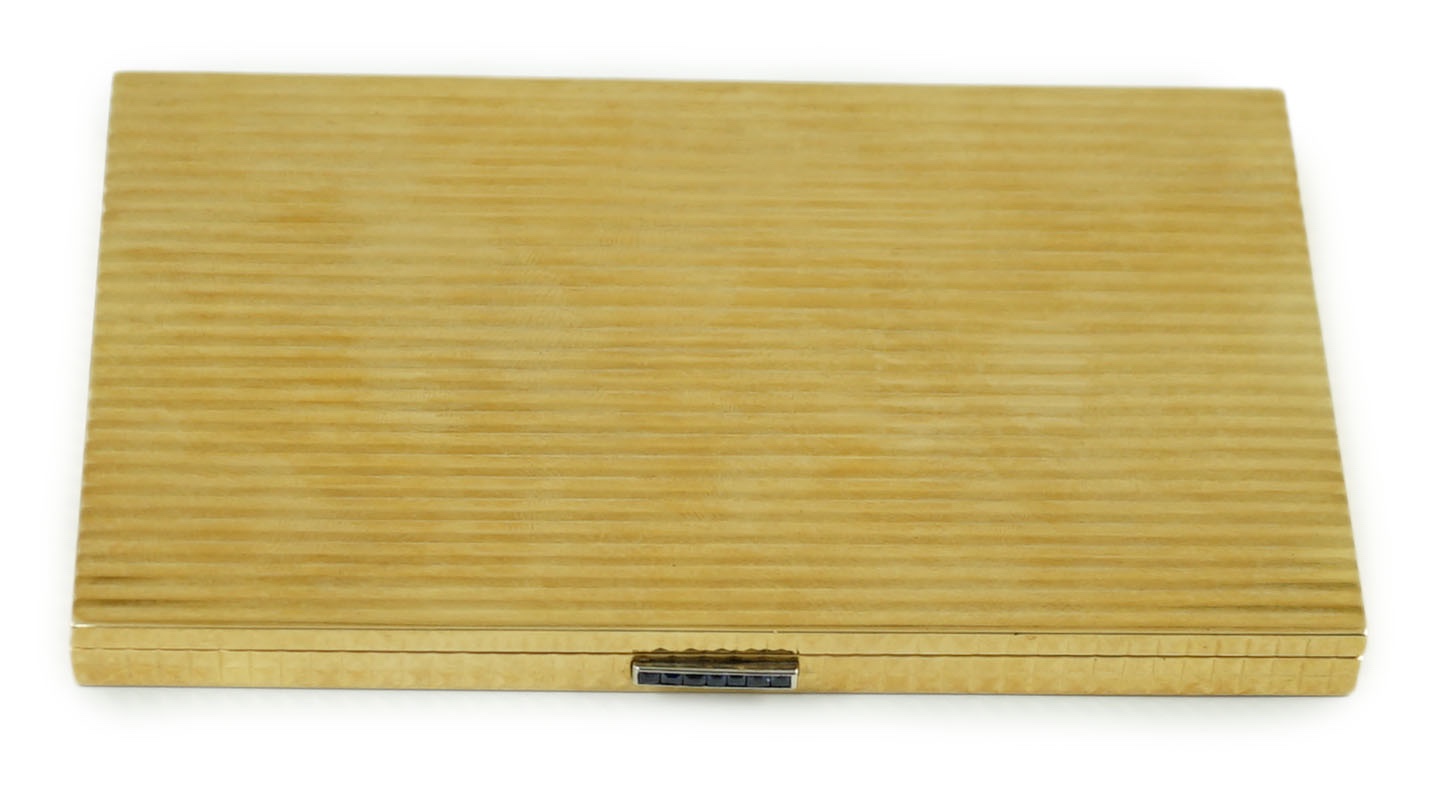 A 20th century Cartier ribbed 18ct gold and sapphire set rectangular cigarette case